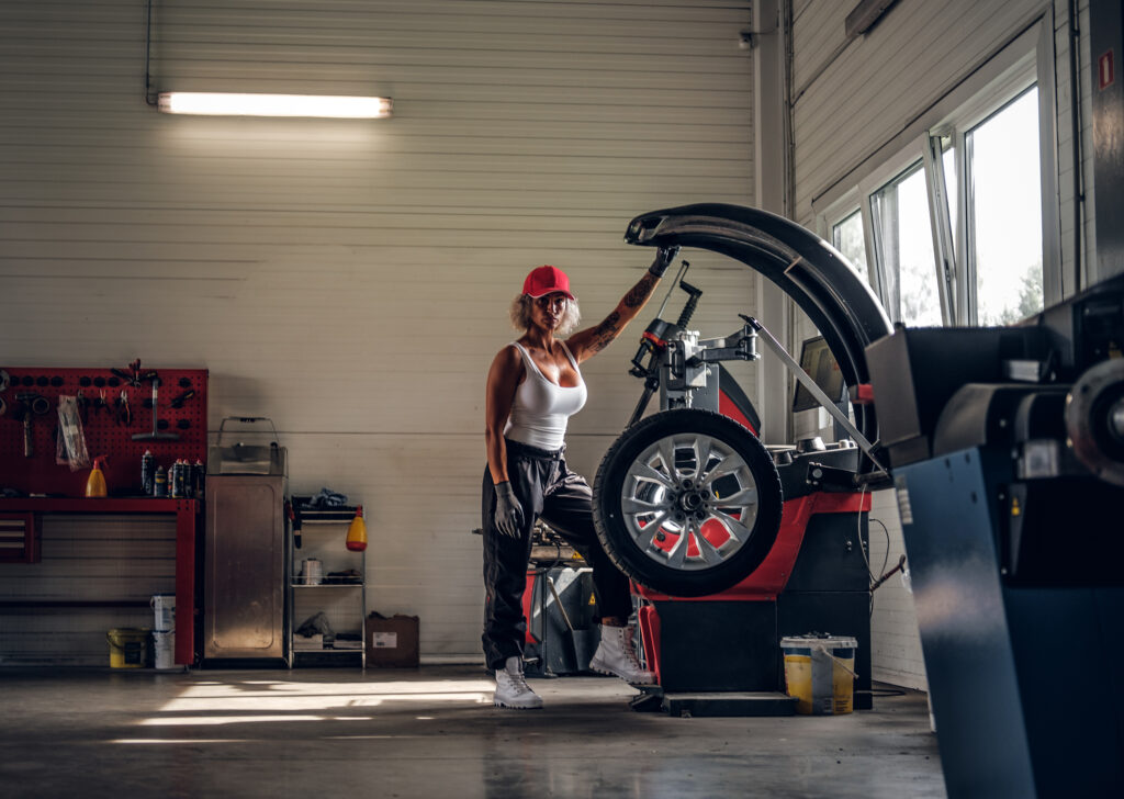 Woman is fixing part of broken car